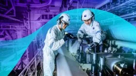 Two MISC maritime engineers inspecting equipment in a ship’s engine room.