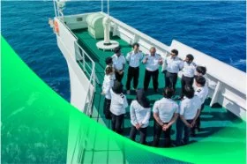 Group of MISC maritime officers in uniform having a meeting on a ship’s deck.